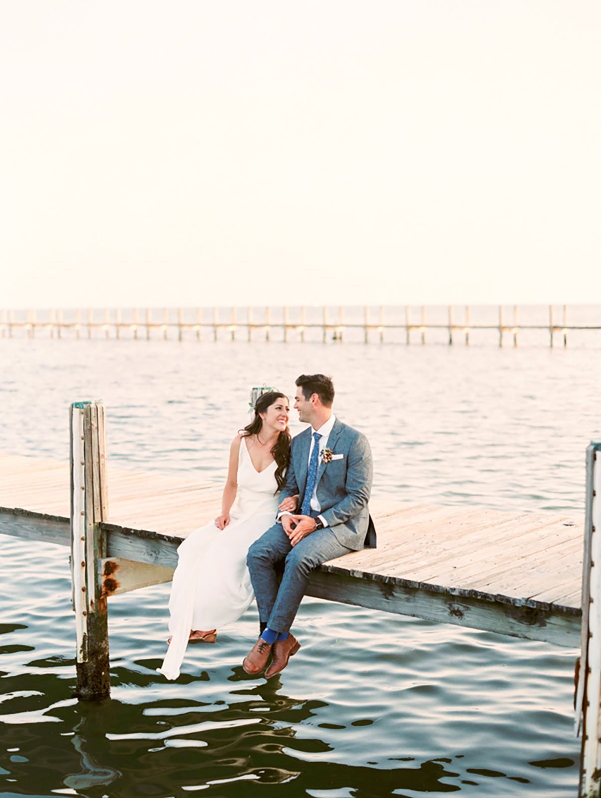 Bride and Groom enjoy a quiet moment on dock of at their waterfront wedding the Caribbean Resort in Islamorada, FL