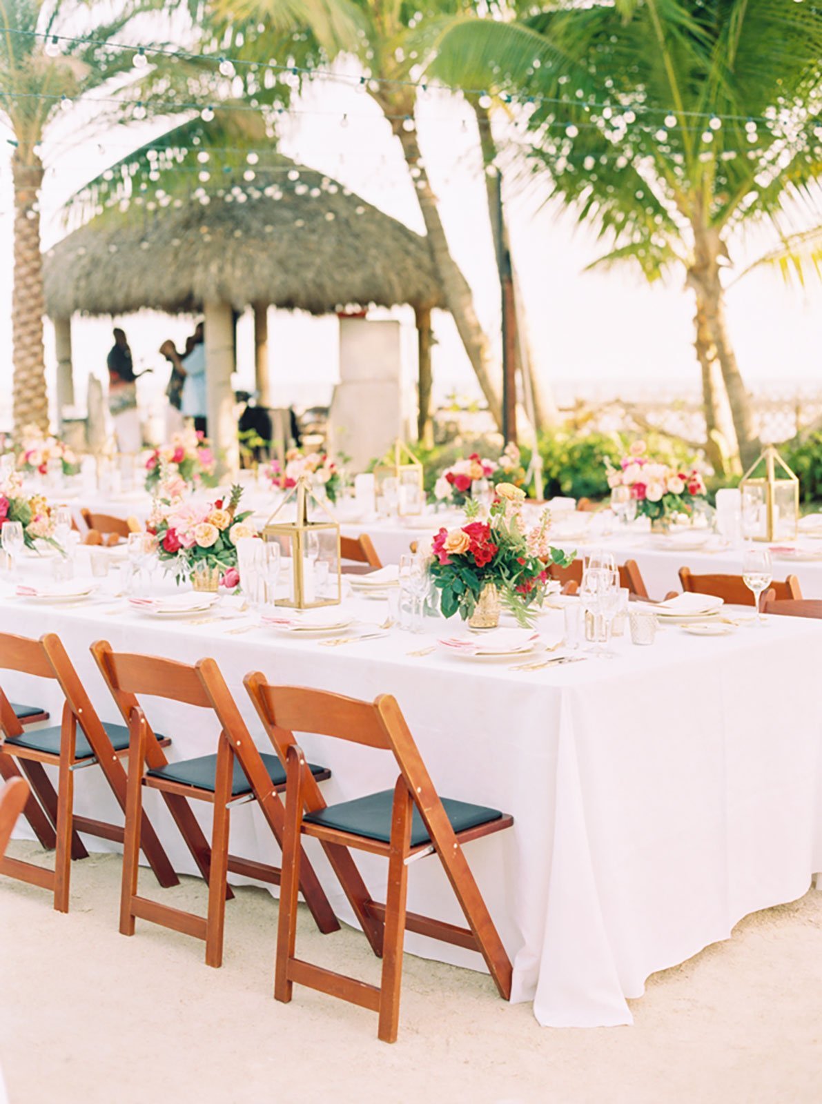 String lights were strewn over the reception to highlight the beach wedding space without obstructing views of the lush tropical landscape