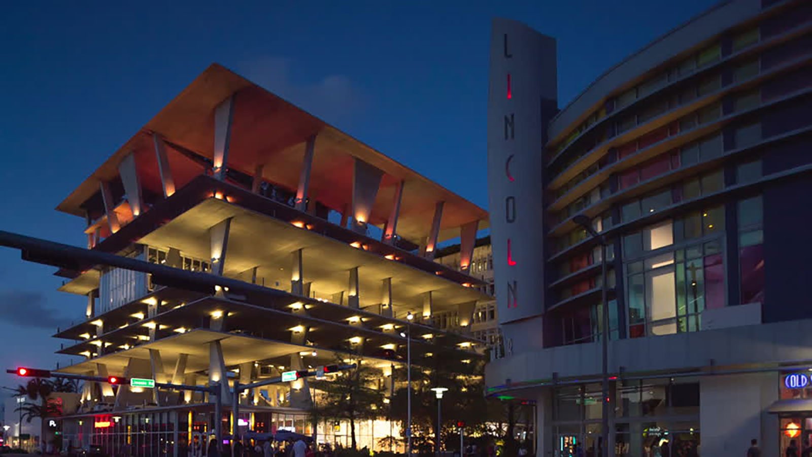 Illuminated Lincoln Road parking structure and vertical Lincoln sign at dusk, a Miami event venue near nightlife and shops