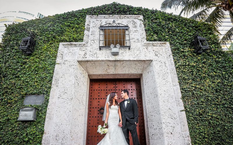 Bride and Groom at the entrance of The Bath Club in Miami Beach