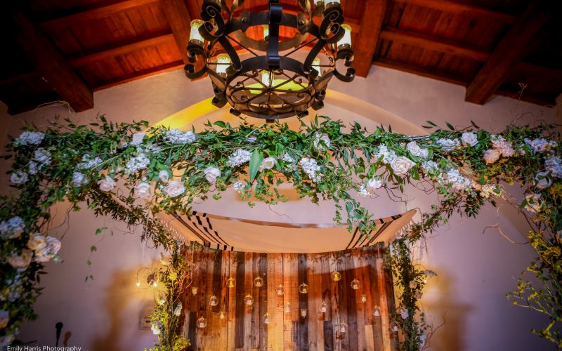 Romantic floral chuppah with a wooden backdrop
