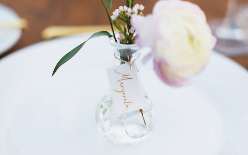Delicate bud vase as place card holder