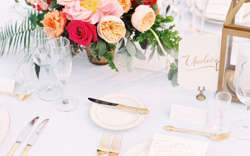 Family-style tables were set with white linens, pink ombre napkins and gold silverware