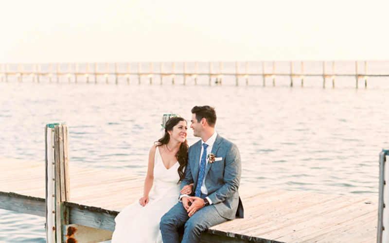Bride and Groom enjoy a quiet moment on dock of at their waterfront wedding the Caribbean Resort in Islamorada, FL