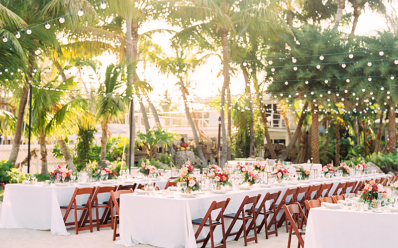 String lights were strewn over the reception to highlight the beach wedding space without obstructing views of the lush tropical landscape