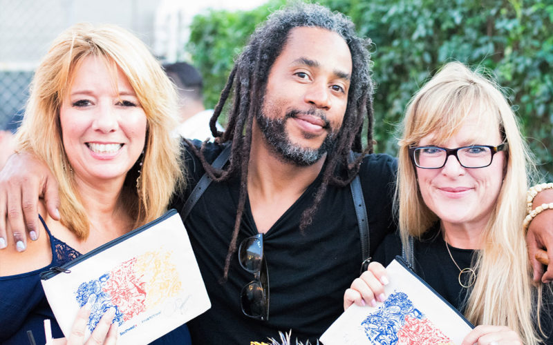 Artist Ruben Ubiera was on site to autograph bags and prints at the Southwest #Heartoftravel event in the FATVillage Arts District