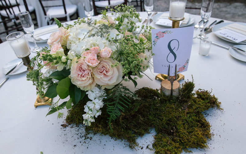 Garden flower centerpiece with moss at Deering Estate wedding reception