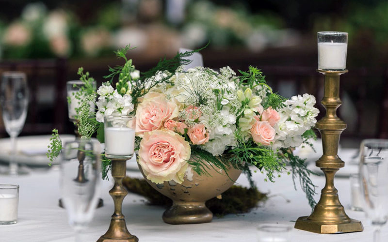 Old-world inspired centerpiece and brass taper candles at Wendy and Marc's Deering Estate wedding reception