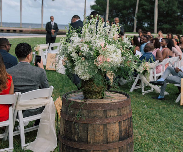 Rustic + romantic wedding aisle décor | Wooden wine barrel flower stands | Deering Estate wedding in Miami