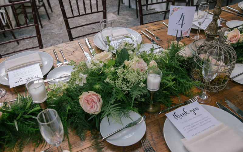 Wild table runner with greenery, queen anne's lace and pale pink roses at this Deering Estate wedding
