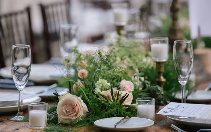 Wild table runner with greenery, queen anne's lace and pale pink roses at this Deering Estate wedding