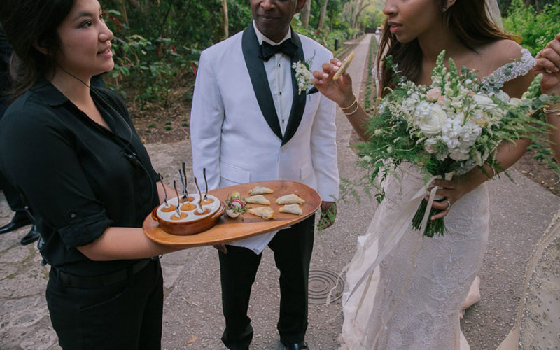 Eggwhites Catering server passing hors d'oeuvres at Deering Estate wedding