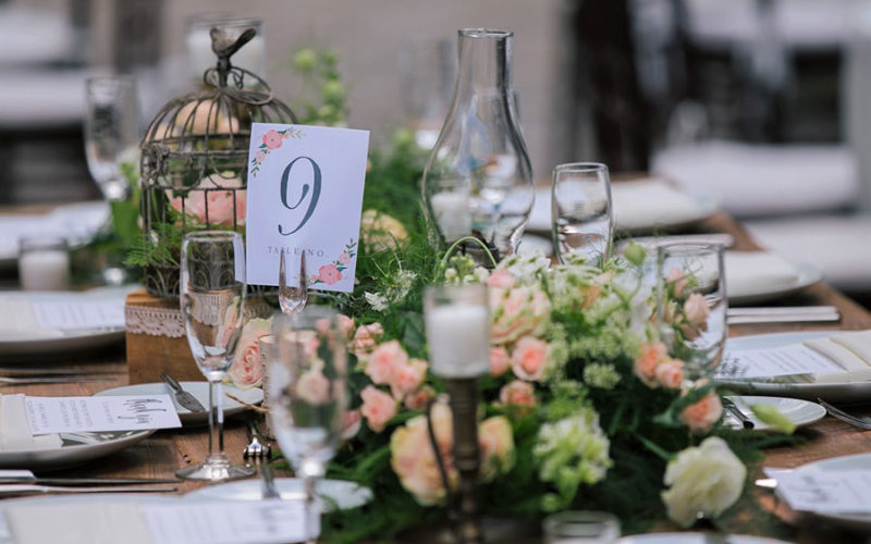 Table numbers match garden wedding theme centerpieces at Wendy and Marc's Deering Estate wedding reception