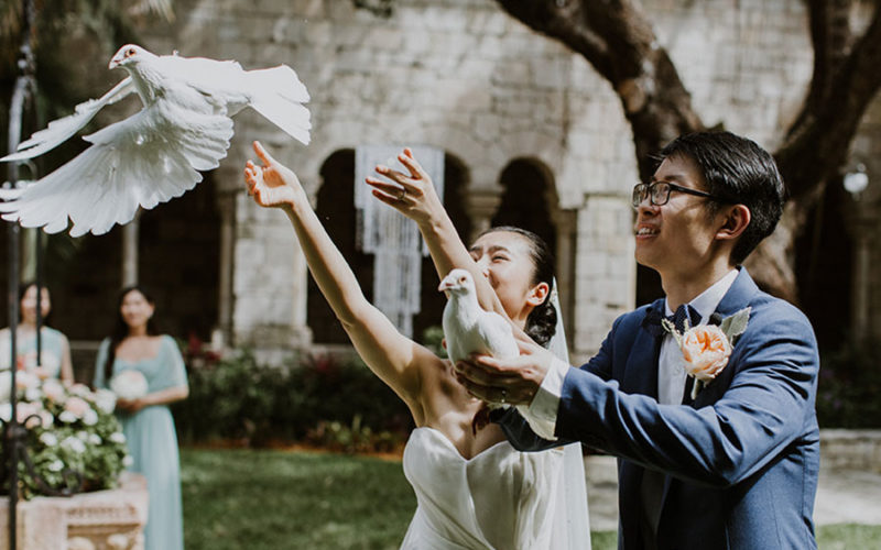 Bride and groom release doves at their Ancient Spanish Monastery wedding