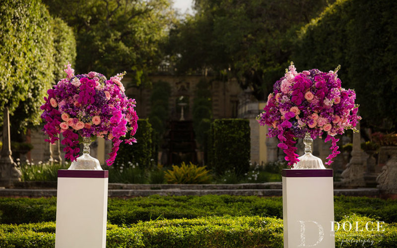 Wedding Ceremony Décor | Stunning floral pedestals in shades of pastel pink, fuschia, magenta and deeper tones of ultra violet at this romantic Vizcaya wedding