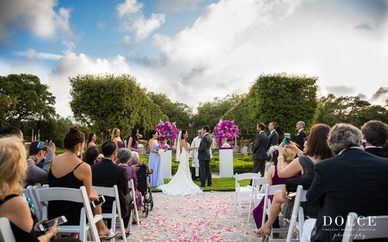 2018 Wedding Colors | Vibrant pink, purple and ultra violet floral urns add a pop of color to this Vizcaya wedding ceremony set-up