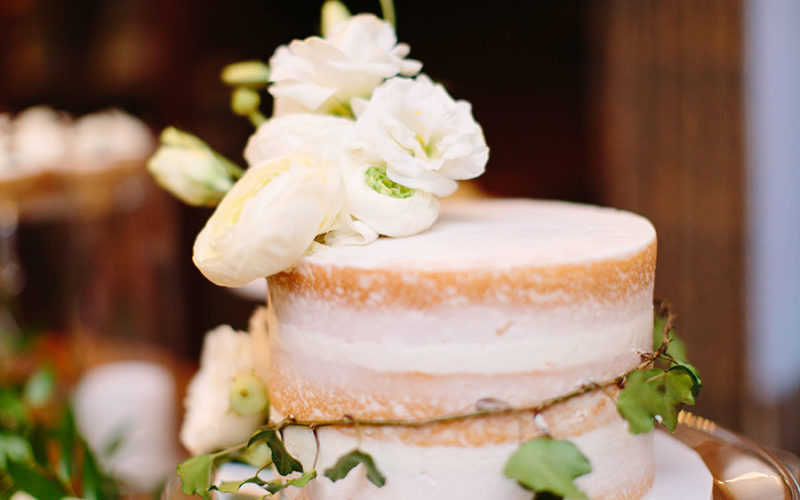 Naked wedding cake adorned with ivy vines and flowers | Deering Estate wedding catering