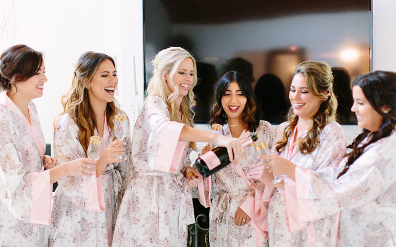 Bride and bridesmaids in matching robes getting ready for Deering Estate wedding
