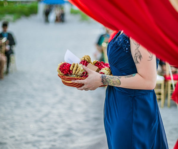 Bridesmaid Holds the Varmala , a garland consisting of flowers that are bunched together on a string in Indian culture.