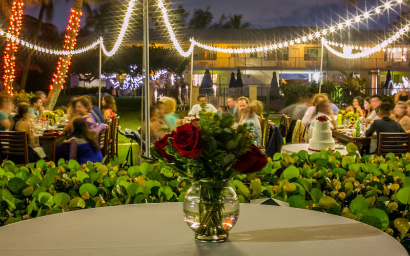 Red rose centerpiece at outdoor Indian wedding reception