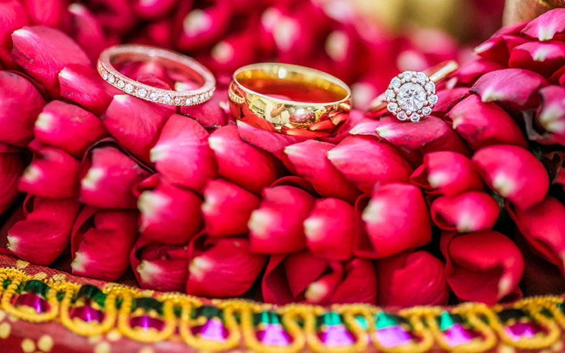 Varmala of rose petals showcase wedding rings