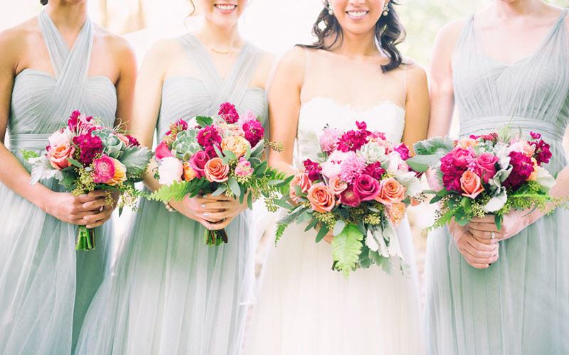 Colorful, vibrant bridesmaids bouquets included fuschia and pale peach roses, hot pink freesia, peonies and succulents | Fairchild Garden wedding