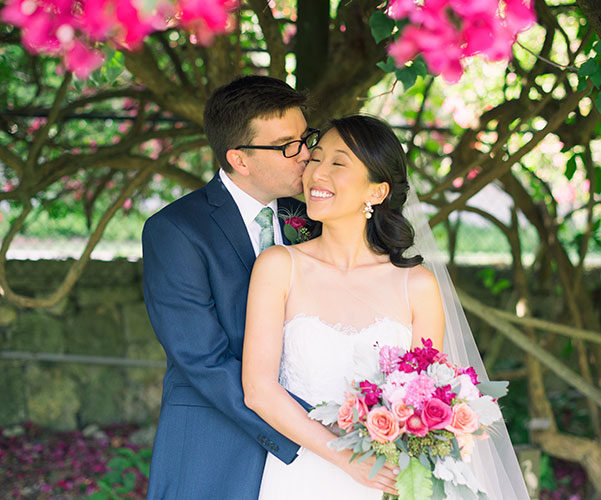 Couple under the bougainvillea at their Fairchild Tropical Botanic Garden wedding