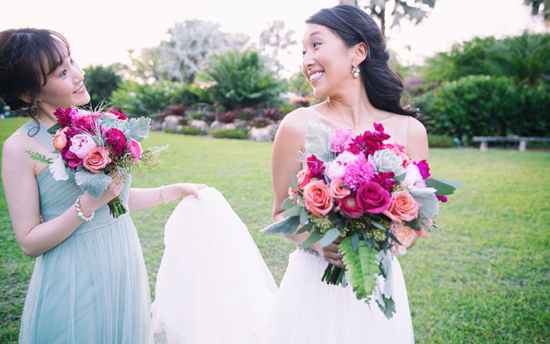 Colorful, vibrant bridal bouquet included fuschia and pale peach roses, hot pink freesia, peonies and succulents | Fairchild Garden wedding