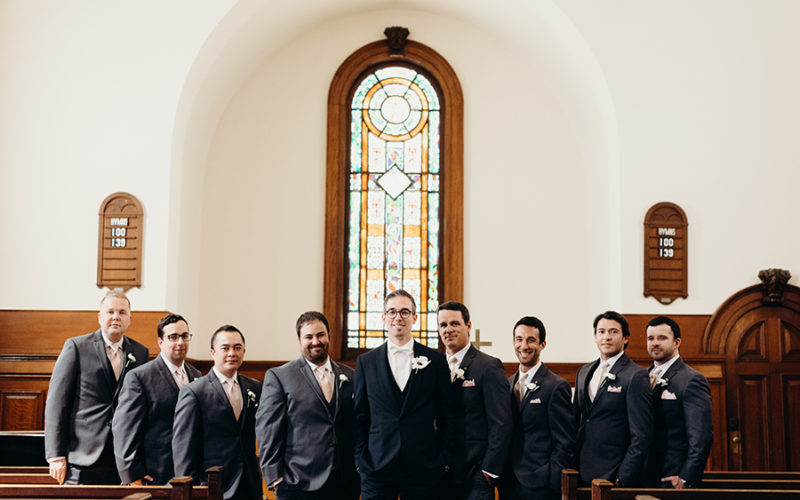 groomsmen in front of stained glass detail | Beautiful churches in Miami for wedding