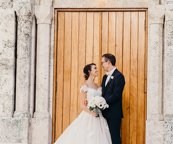 Couple pose in front of Brickell wedding venue | Beautiful churches in Miami for wedding