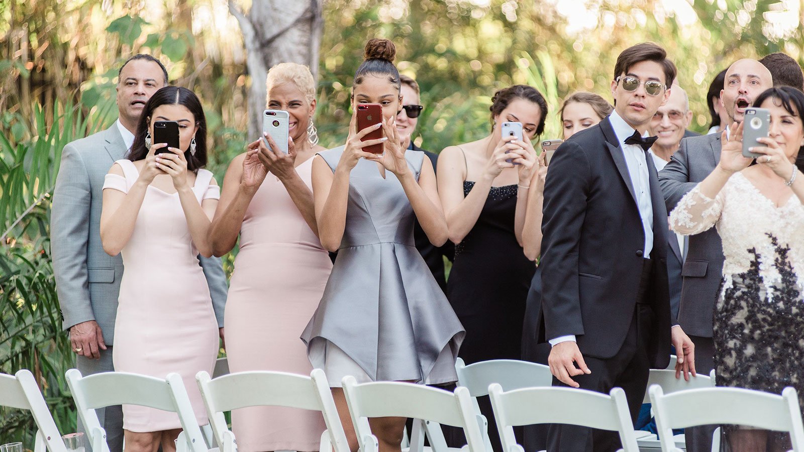 guests with cell phones at wedding ceremony
