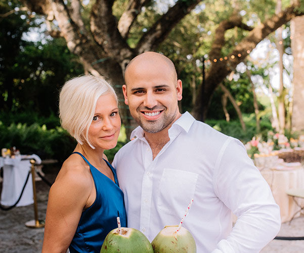tropical wedding theme | guests enjoy fresh coconut milk