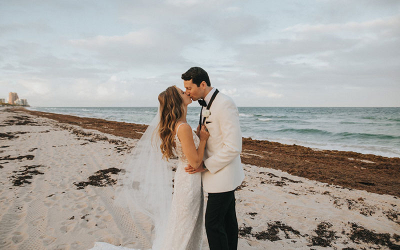 wedding couple on beach at bonnet house museum and garden