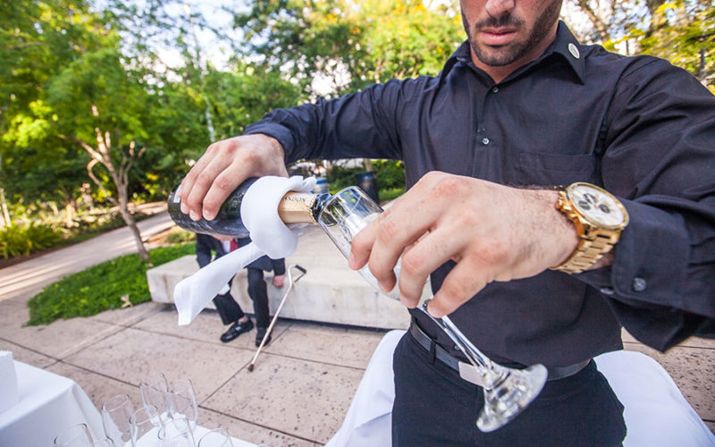 miami beach botanical garden wedding | bartender pours champagne